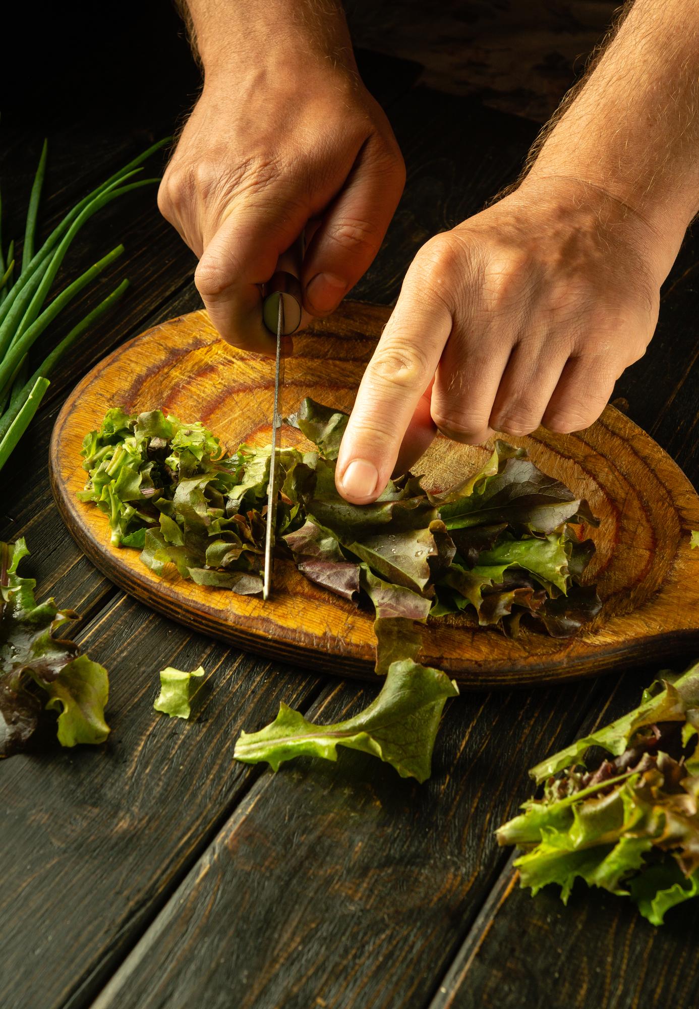 Chef preparing a rustic plated dish with herbs